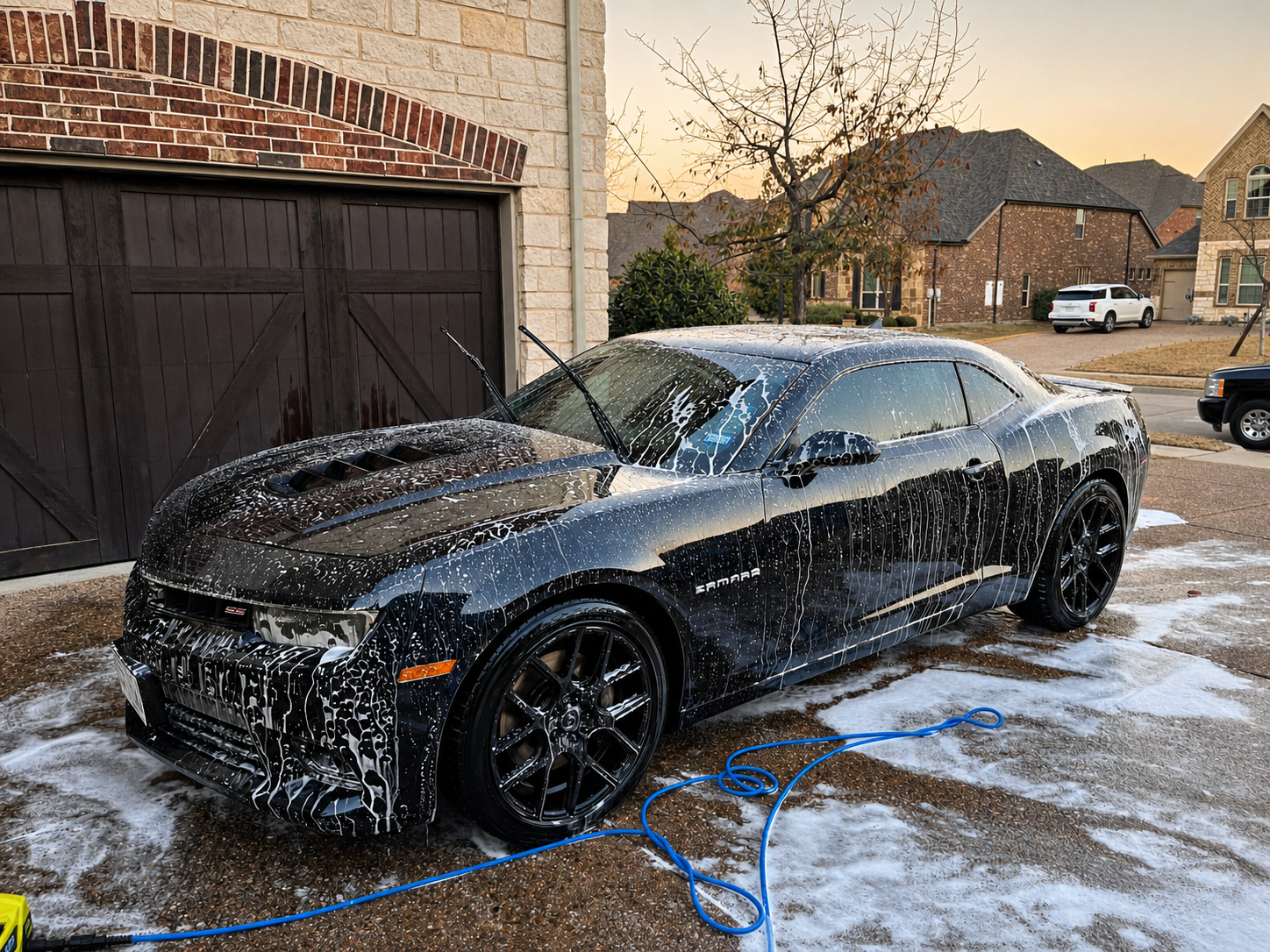 Black Chevrolet Camaro being professionally foam washed by Evo Auto Details in Roanoke TX