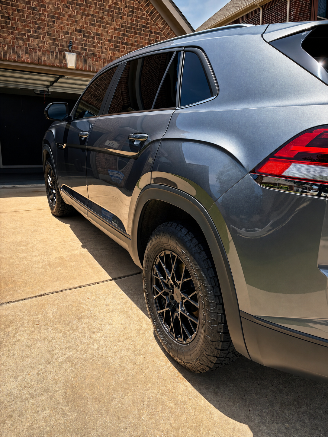 Gold water beads on a ceramic coated black car surface demonstrating hydrophobic properties