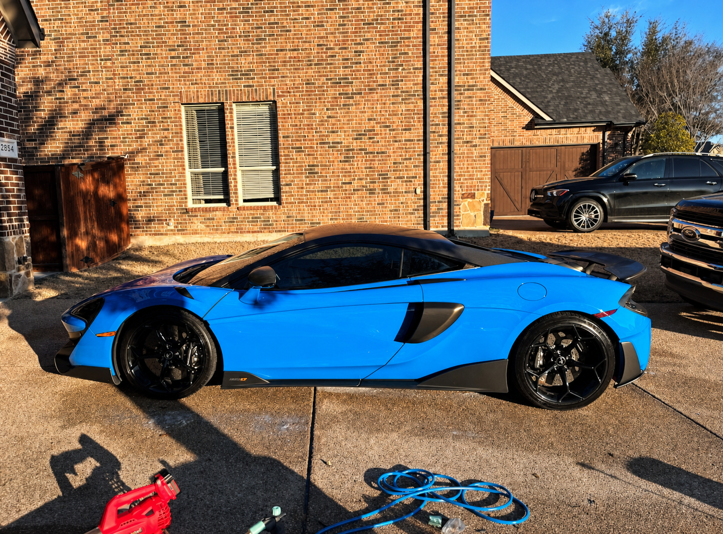 Blue McLaren supercar detailed by Evo Auto Details at a client home in DFW