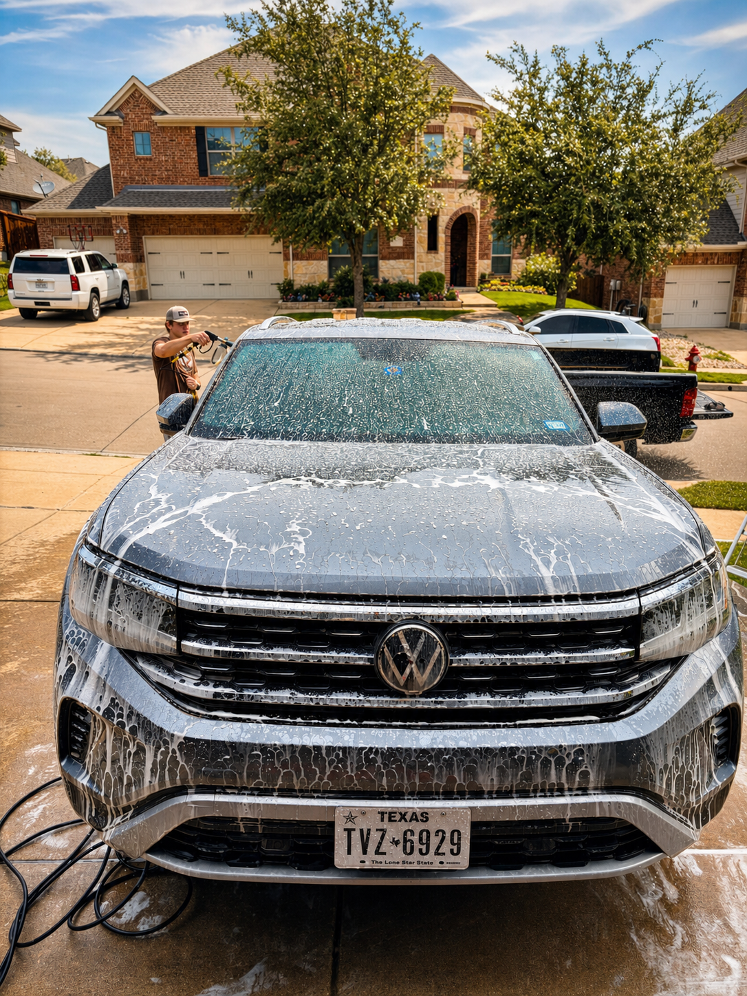 Evo Auto Details mobile service team detailing a car at a client's home in DFW